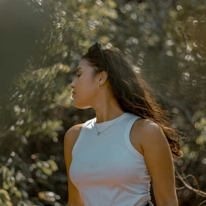 a woman standing in front of a forest
